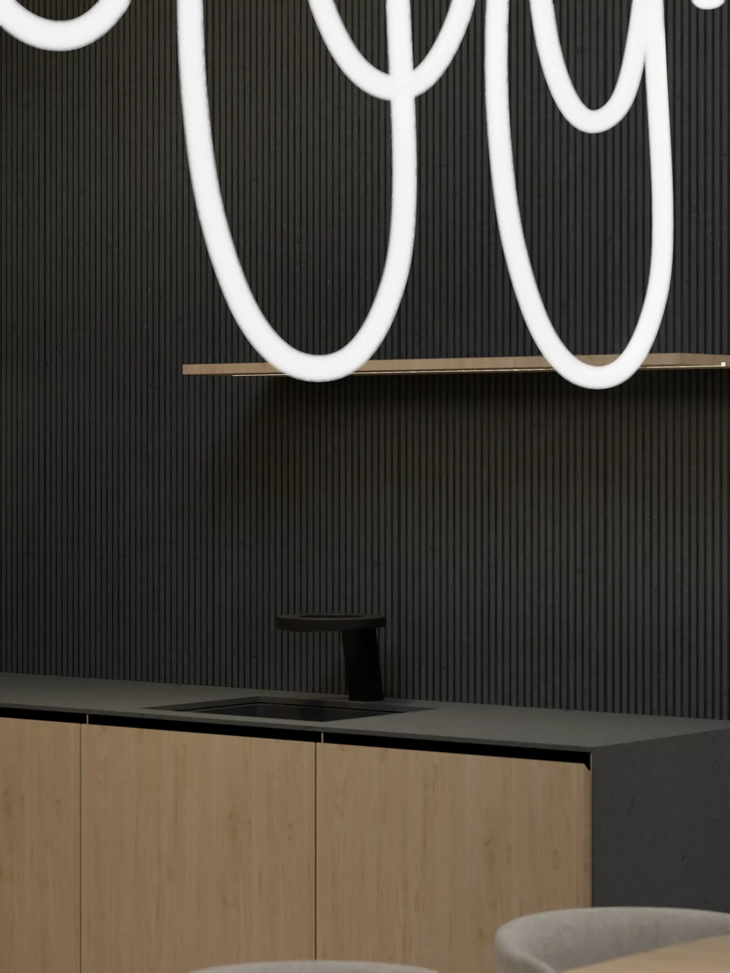 A dark kitchenette against a green ribbed wall under looped light