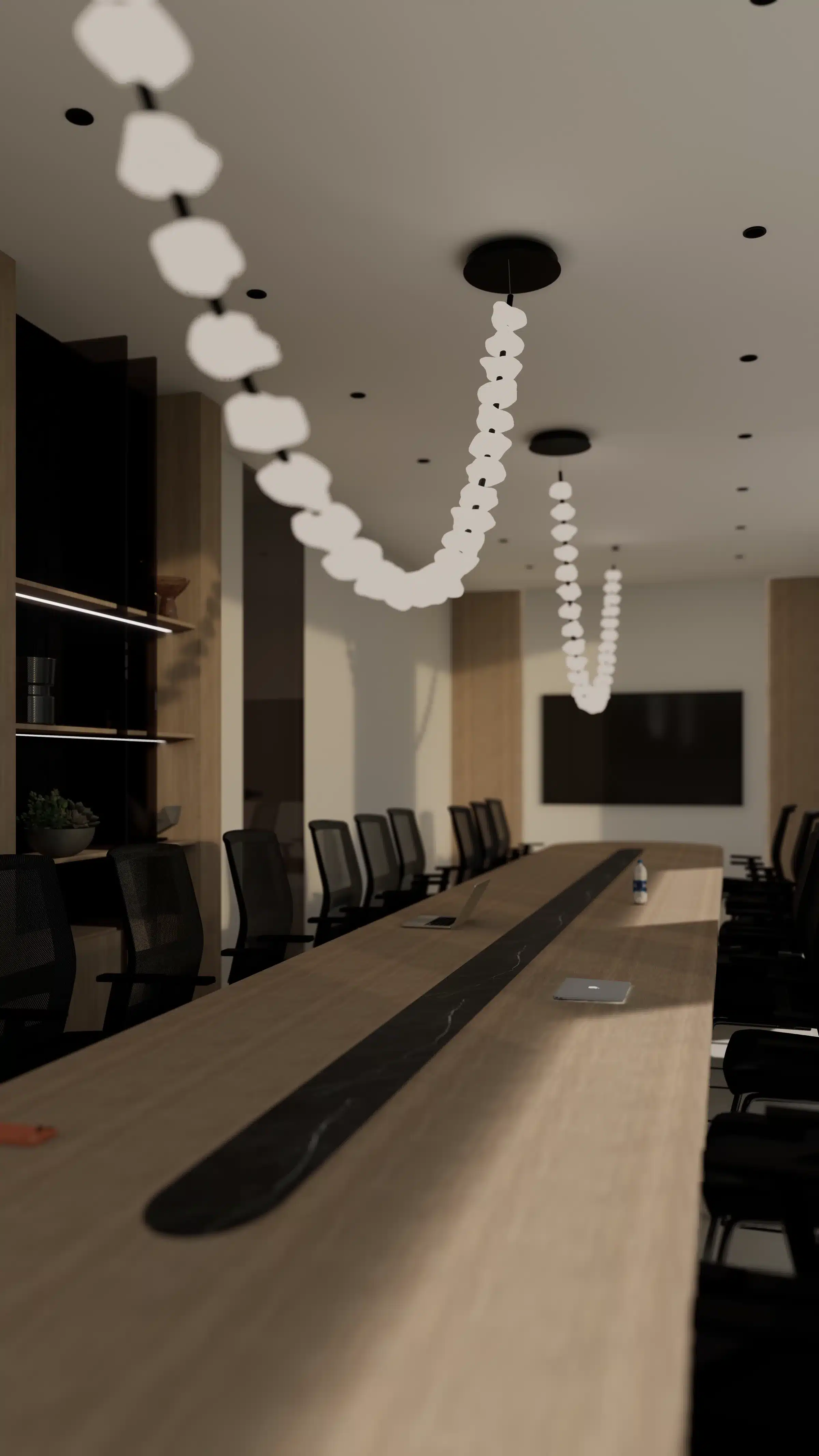 Conference seating beneath flower-like pendants along a timber wall